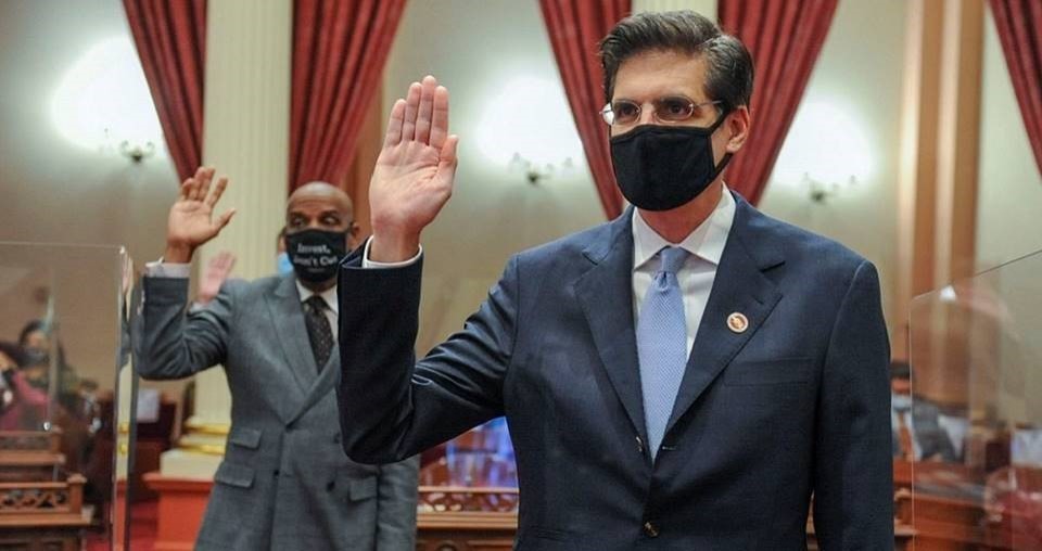 Senator Josh Becker, right, takes his Oath of Office in the Senate Chamber of the state Capitol